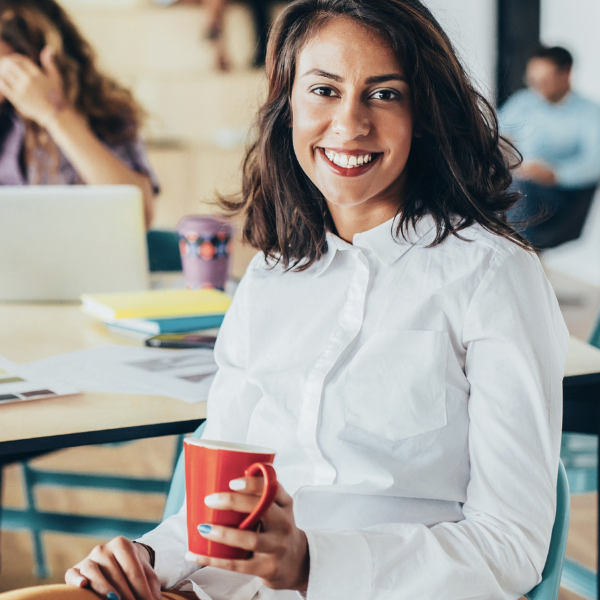 smiling business woman with a red cup